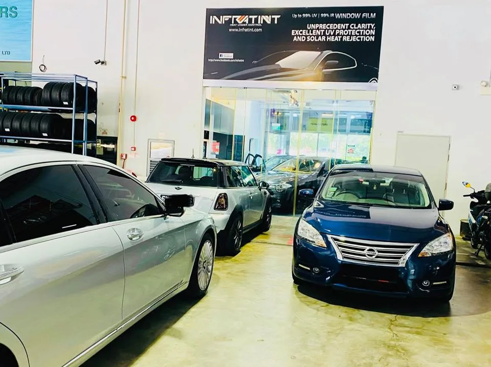Blue Nissan Sylphy, Mini Cooper and silver Mercedes-Benz lined up at Infratint Singapore