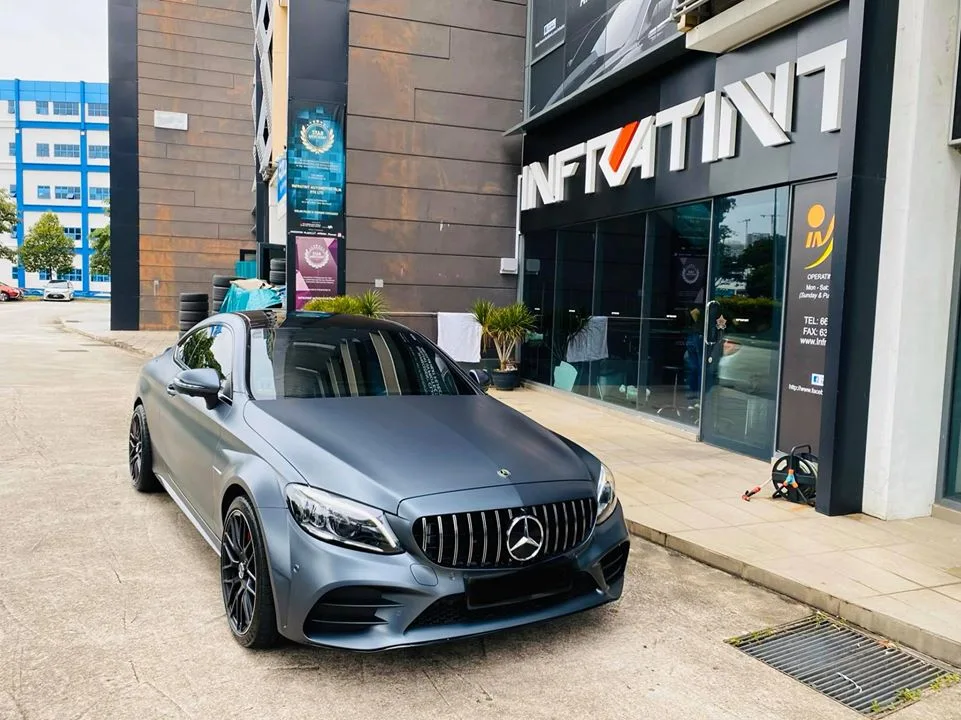 Matte grey Mercedes-Benz C-Class coupe parked outside the Infratint Singapore shopfront