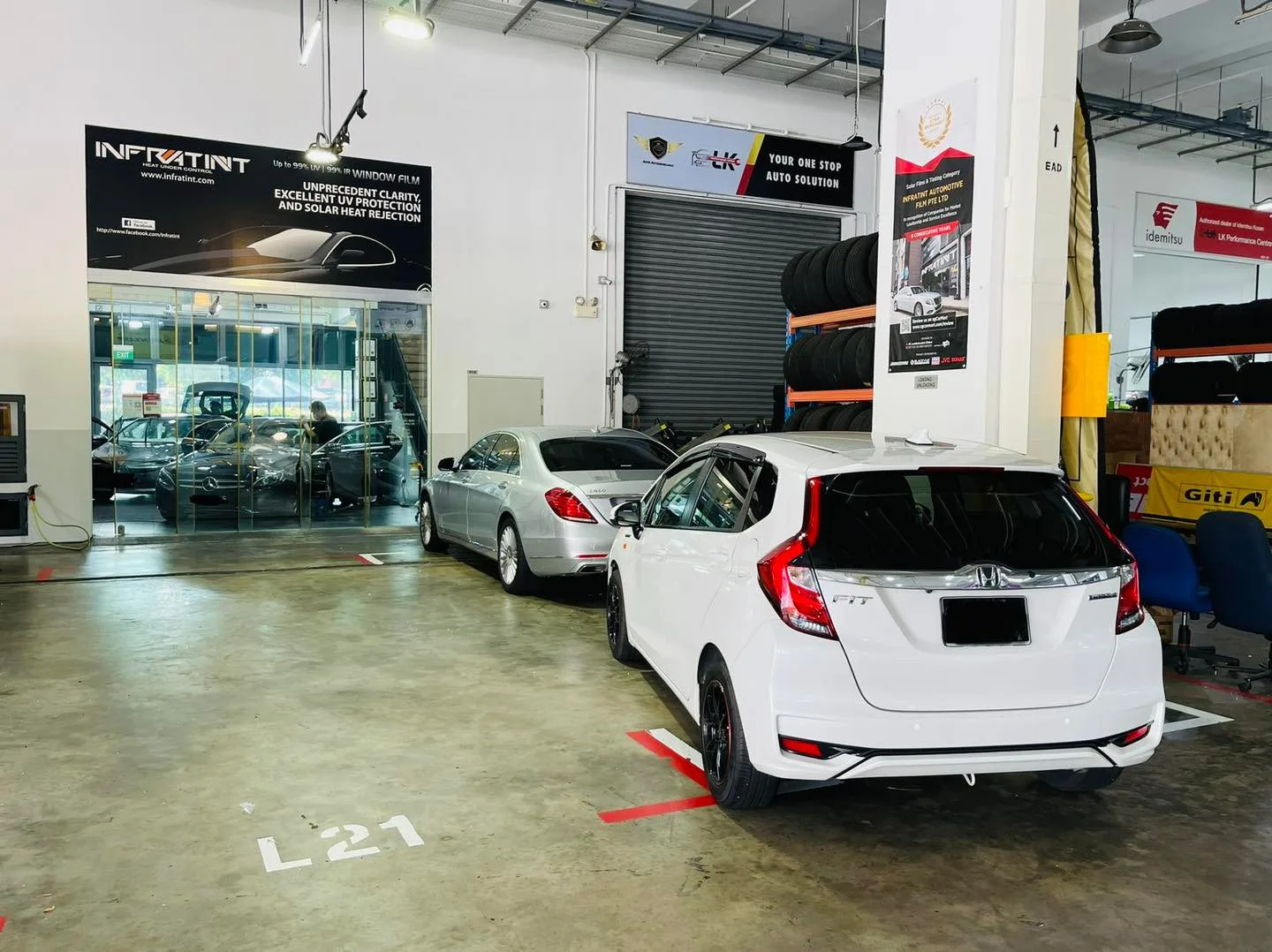 White Honda hatchback and silver Mercedes-Benz at Infratint Singapore workshop
