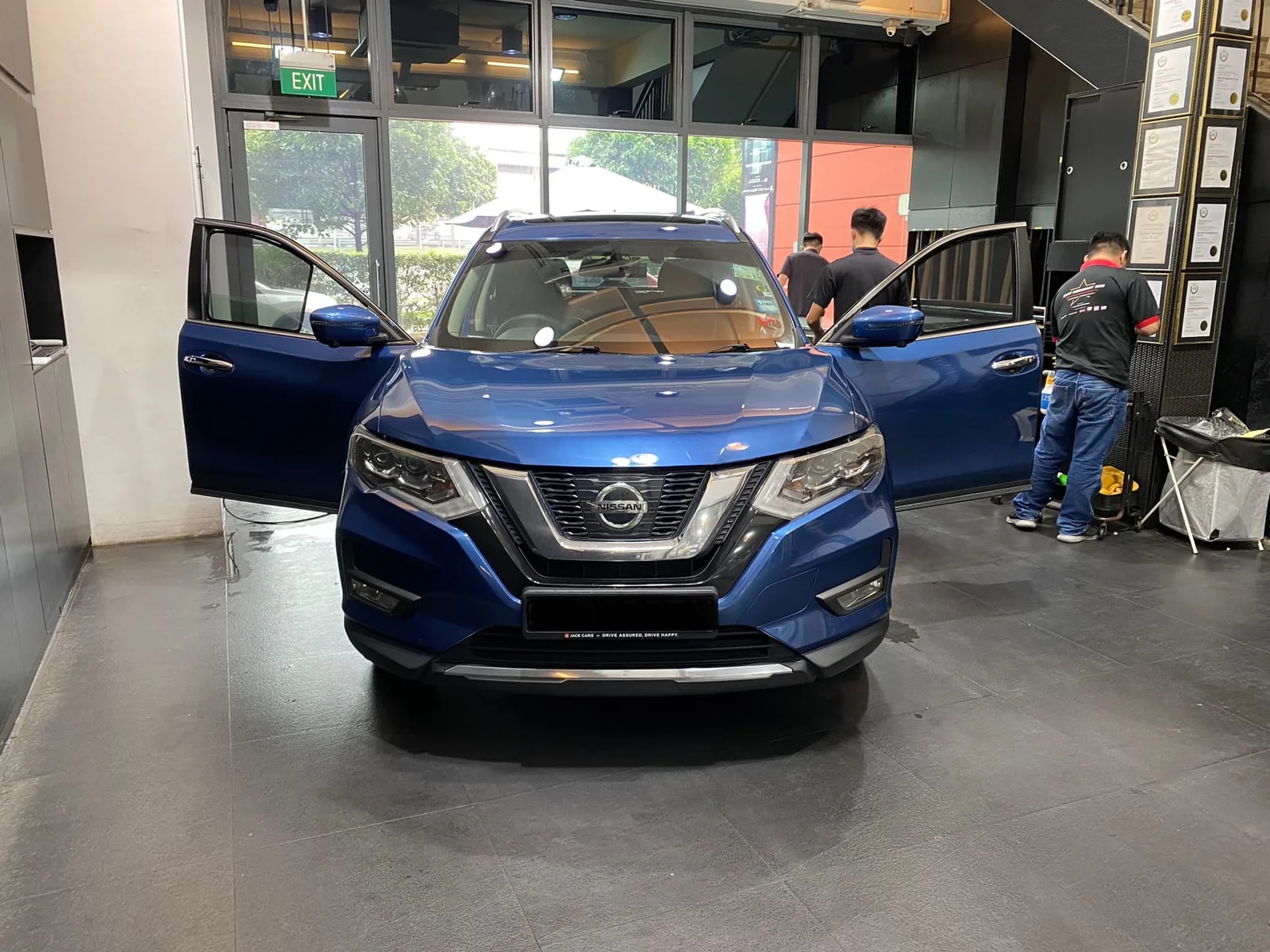 Blue Nissan X-Trail being tinted with doors open at Infratint Singapore