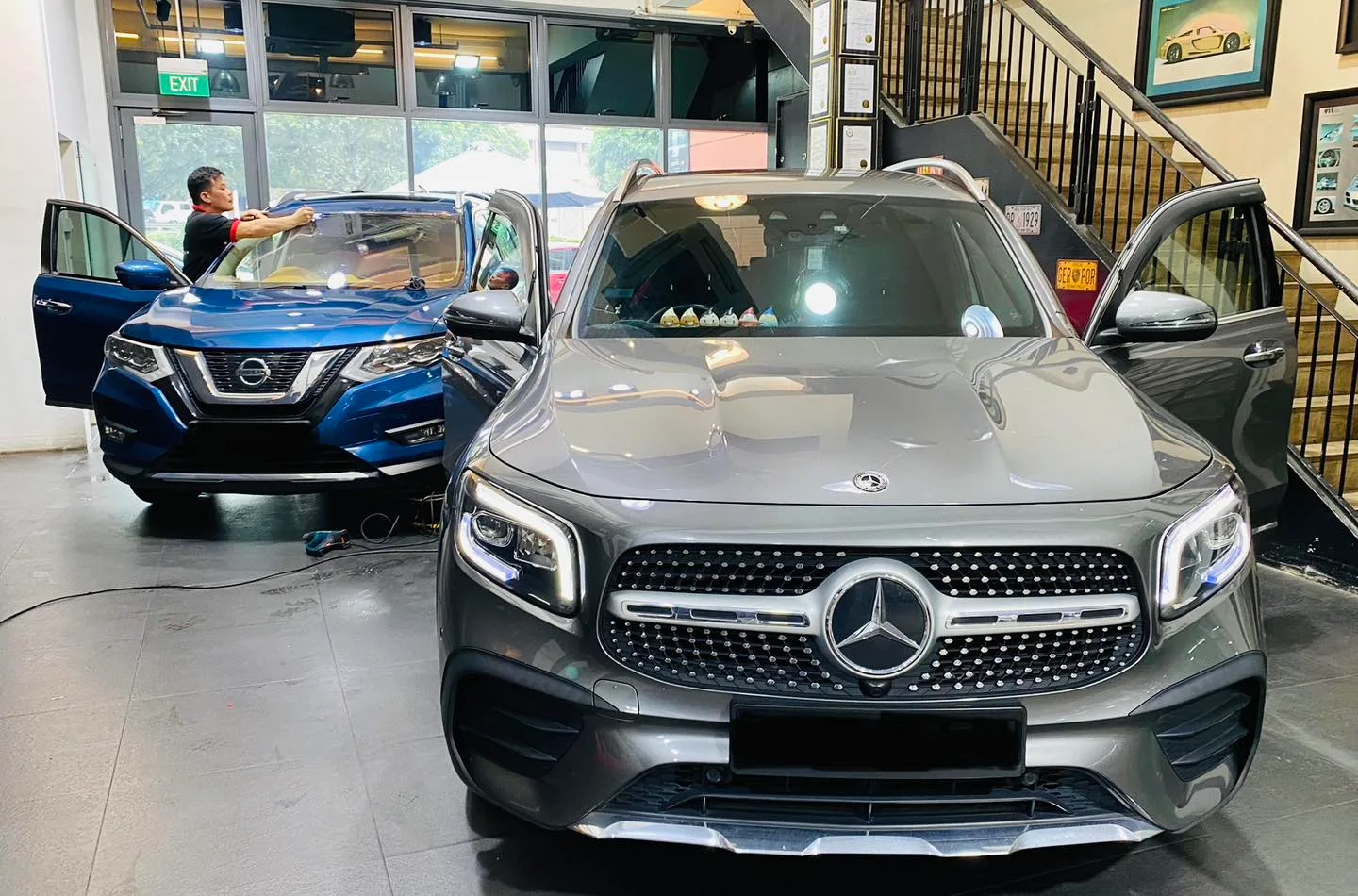 Grey Mercedes-Benz GLB and blue Nissan X-Trail inside the Infratint Singapore showroom