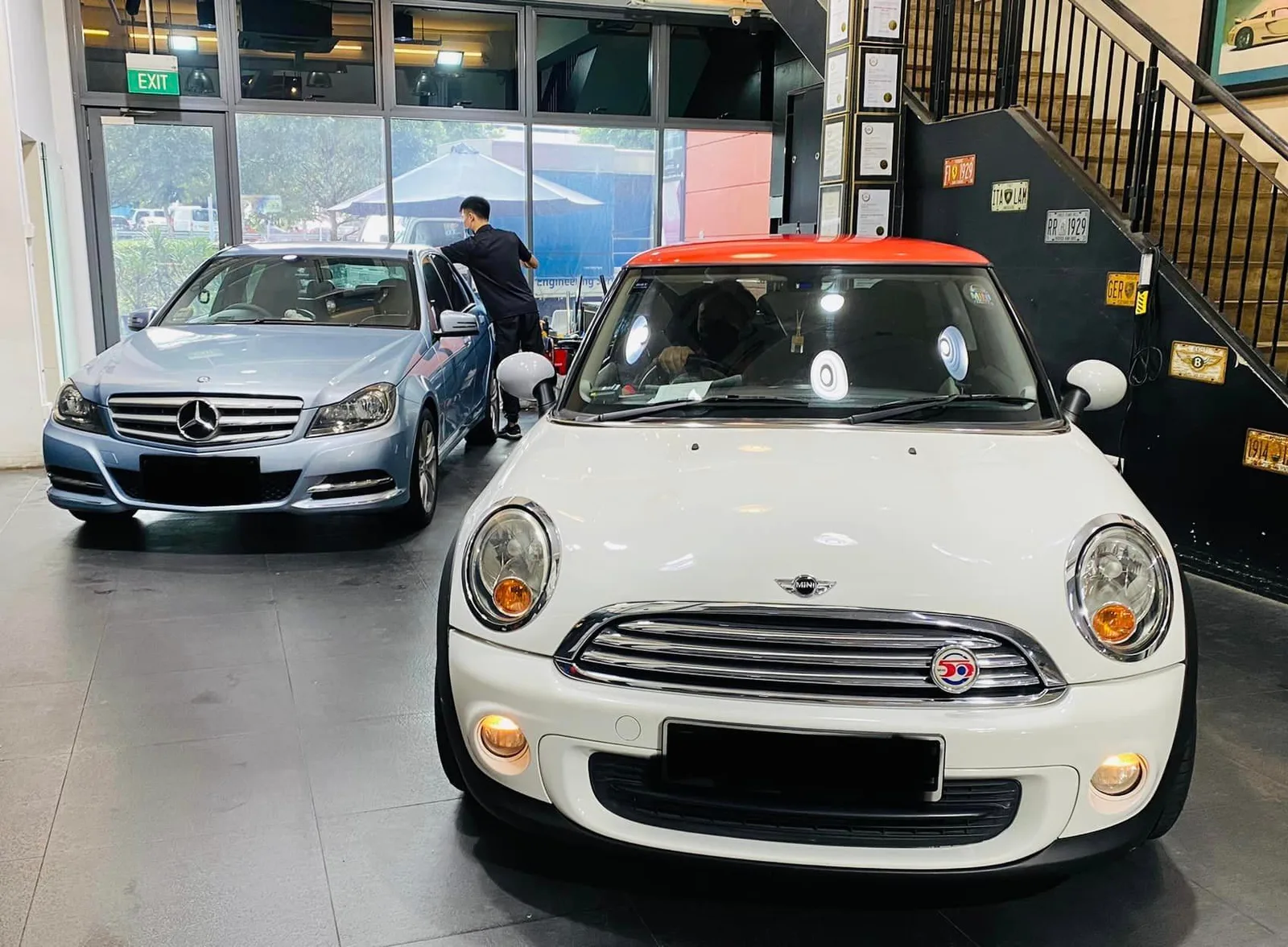 White Mini Cooper with orange roof beside a light blue Mercedes-Benz C-Class at Infratint Singapore