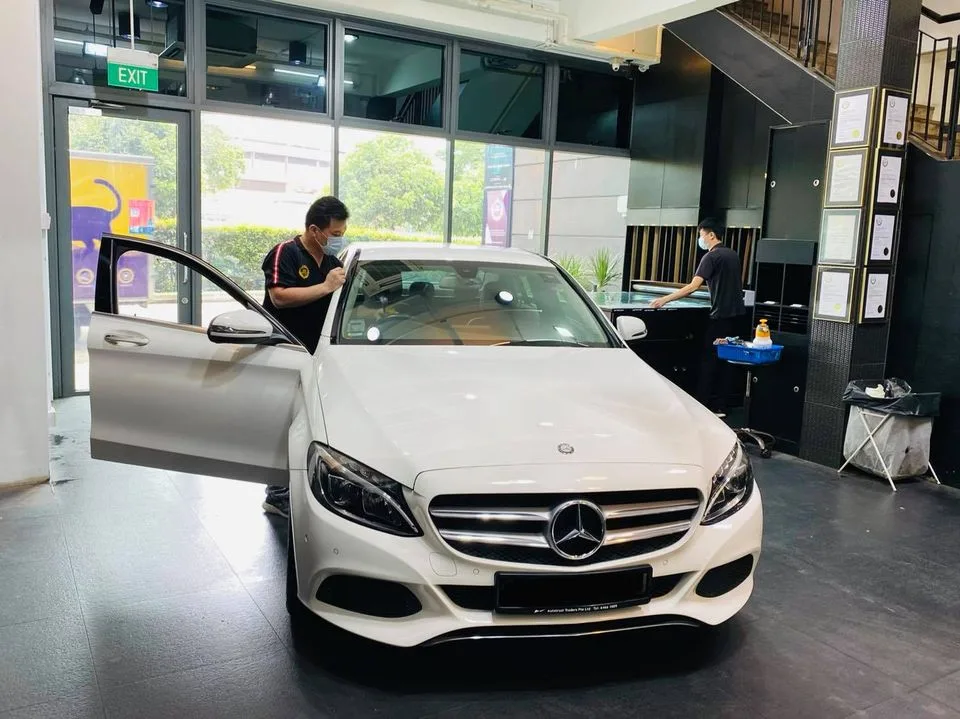 White Mercedes-Benz C-Class being tinted by an installer at Infratint Singapore