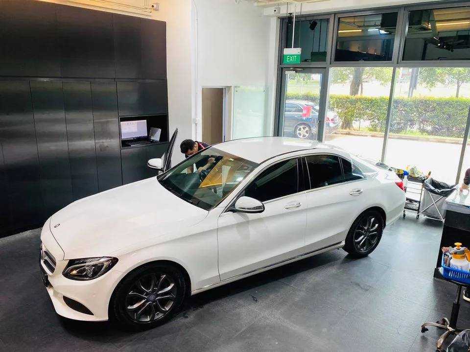 Overhead view of a white Mercedes-Benz C-Class with tinted windows at Infratint Singapore