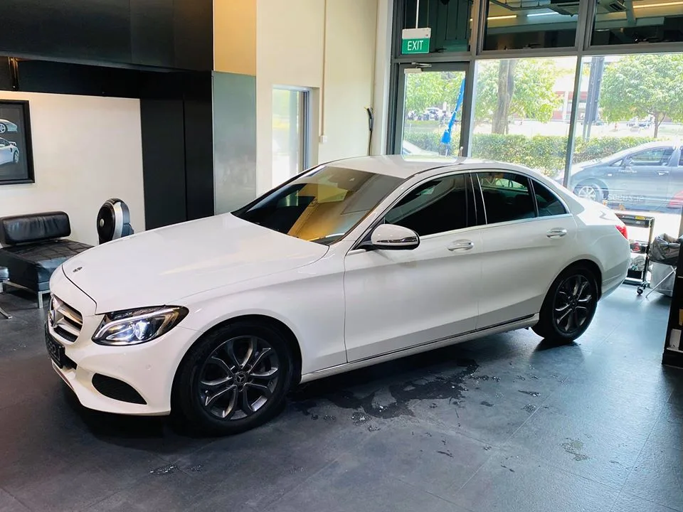 Side profile of a white Mercedes-Benz C-Class with tinted windows at Infratint Singapore