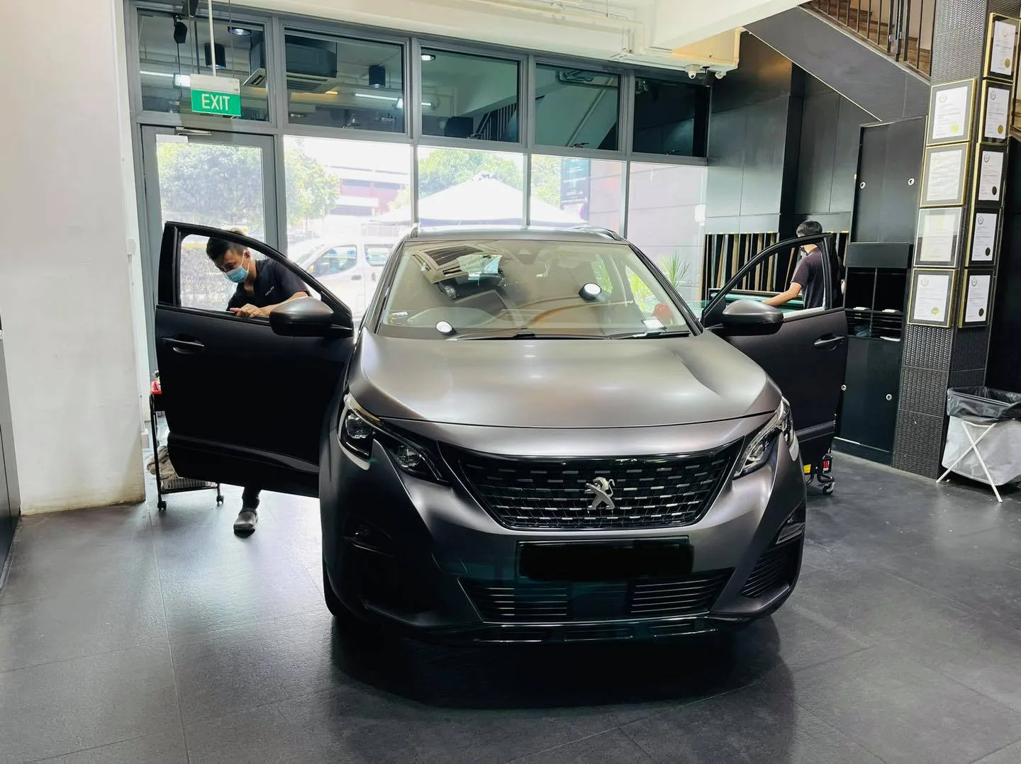 Matte grey Peugeot SUV with door open during window tinting at Infratint Singapore