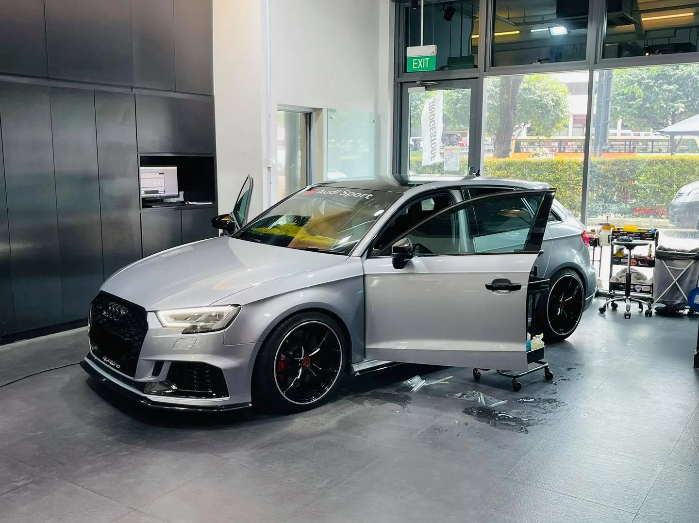 Silver Audi hatch with door open during window tinting at Infratint Singapore