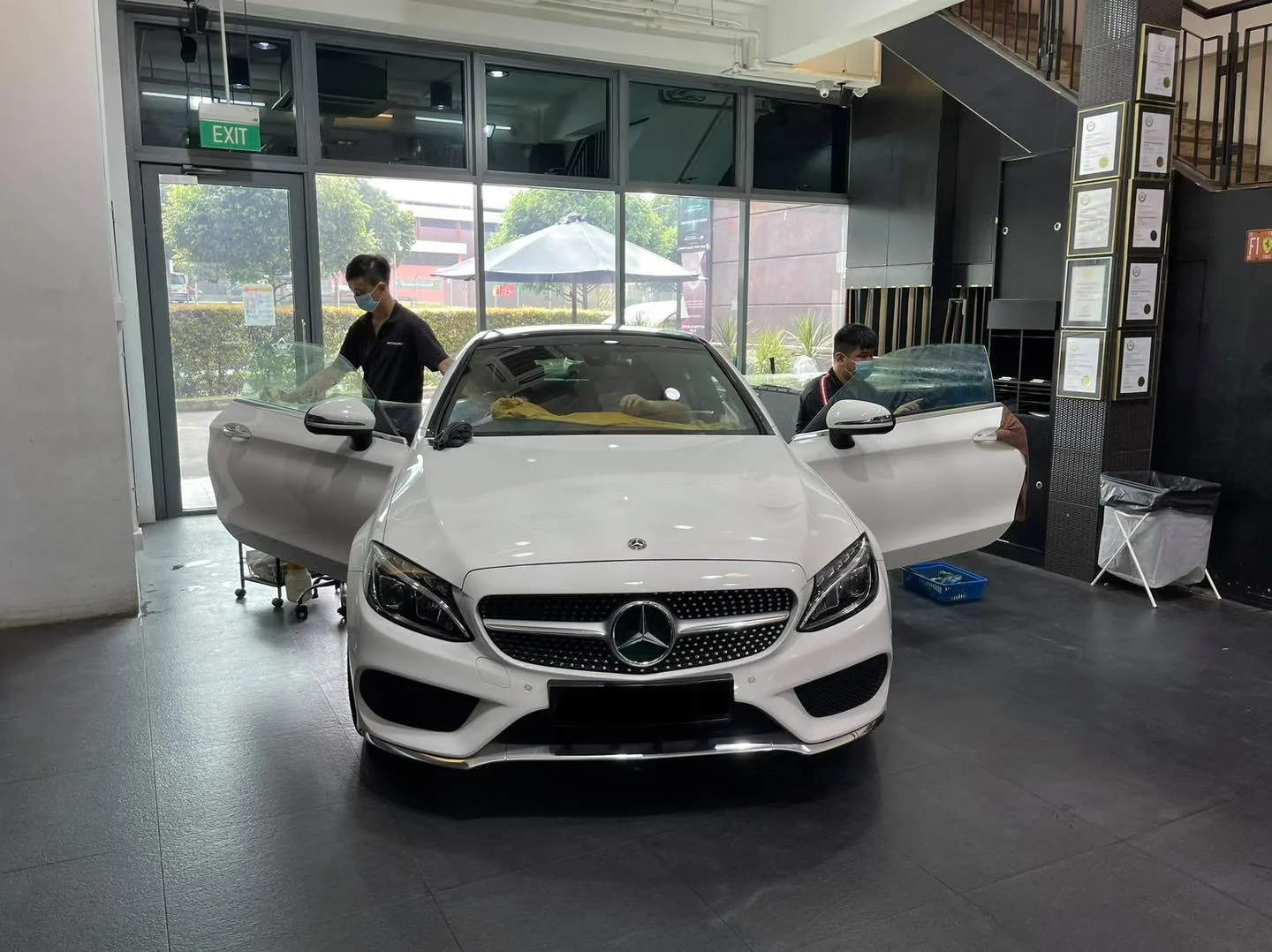 White Mercedes-Benz coupe front view during window tinting at Infratint Singapore