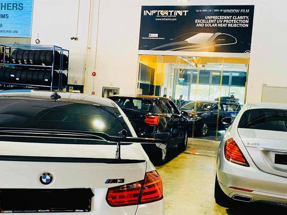 White BMW M3 and silver Mercedes-Benz sedan seen from the rear at Infratint Singapore