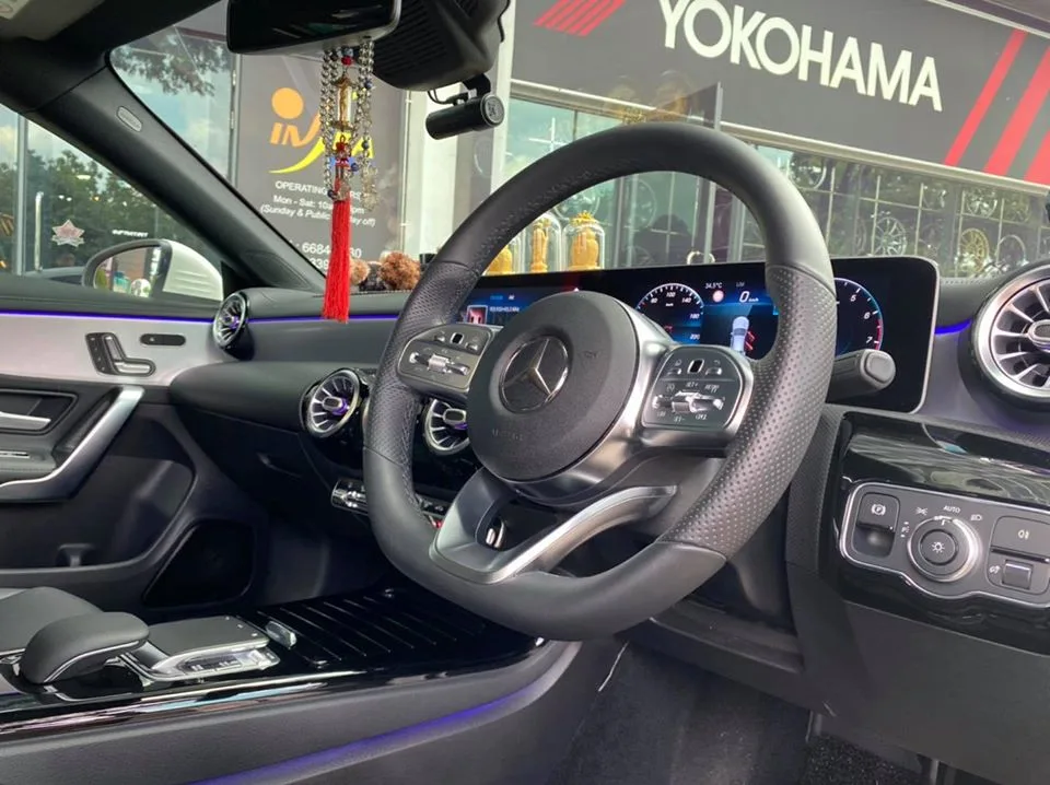 Steering wheel and digital dashboard inside a Mercedes-Benz CLA after tinting at Infratint Singapore
