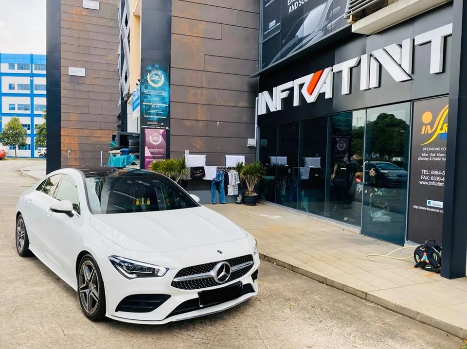 White Mercedes-Benz CLA 180 parked outside the Infratint Singapore shopfront after window tinting