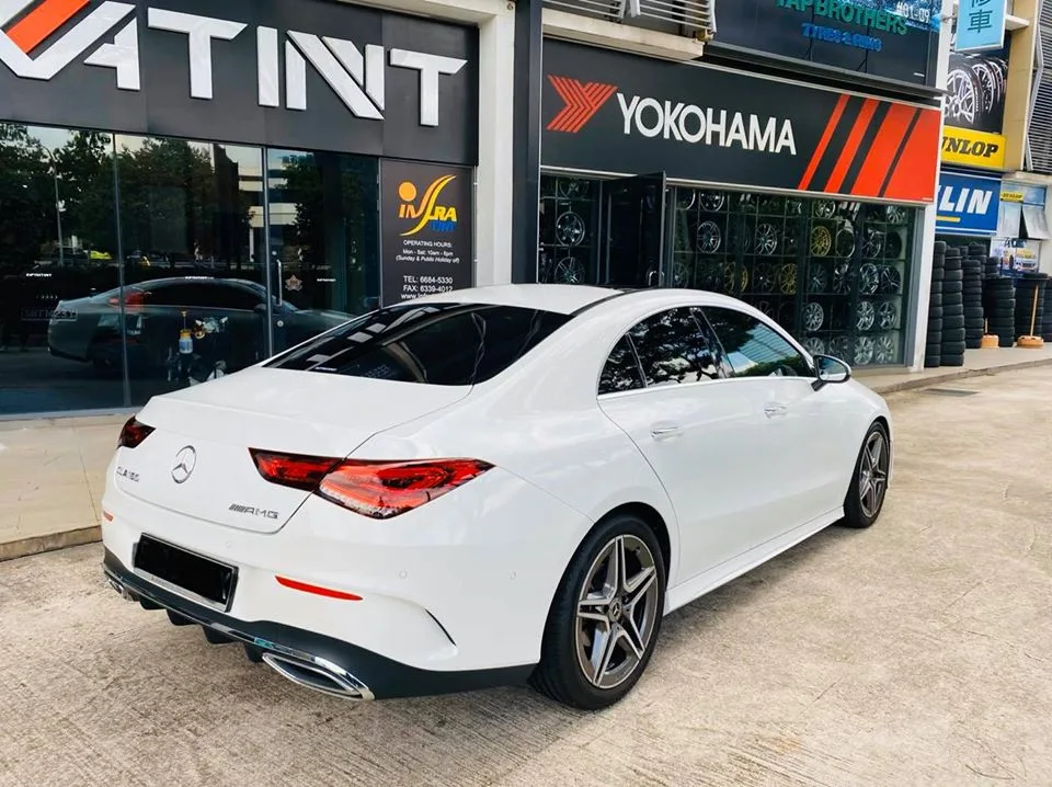 Rear three-quarter of a white Mercedes-Benz CLA 180 with tinted windows at Infratint Singapore