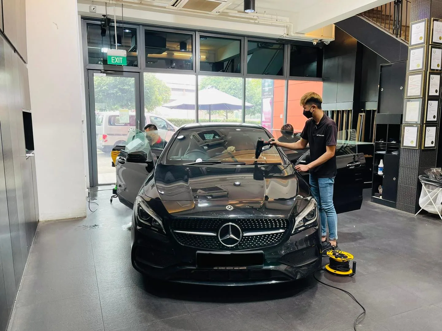 Black Mercedes-Benz CLA being prepared for window tinting at Infratint Singapore