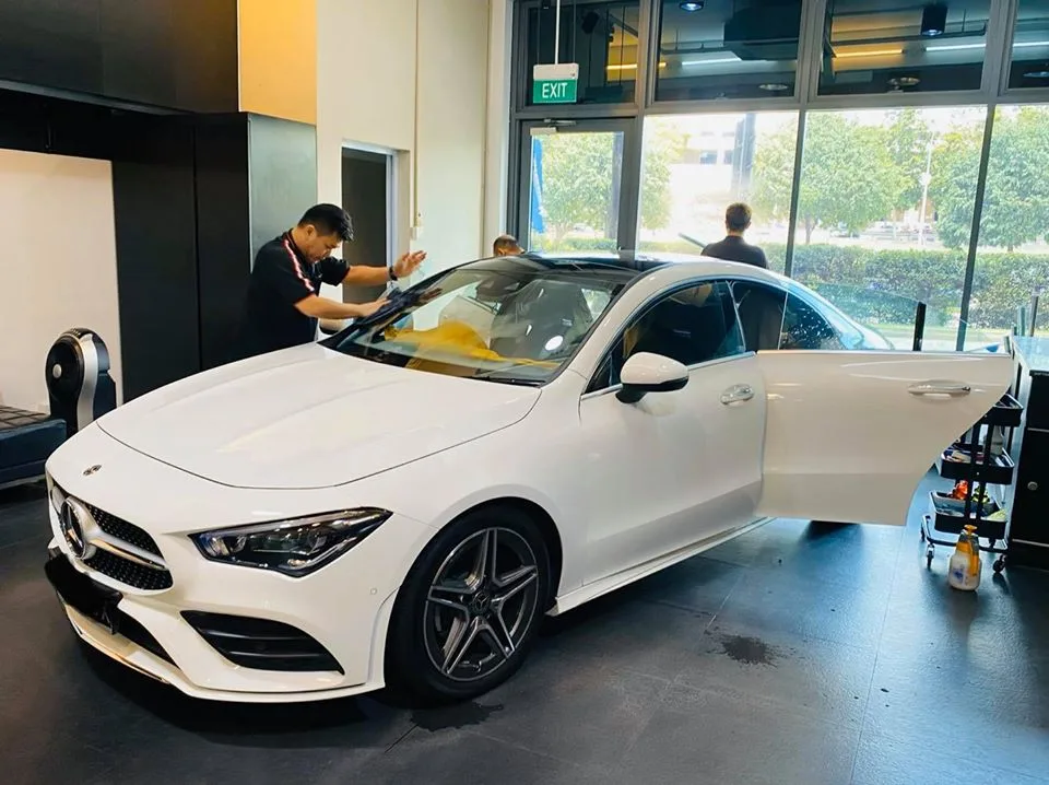 White Mercedes-Benz CLA with door open during window tinting at Infratint Singapore