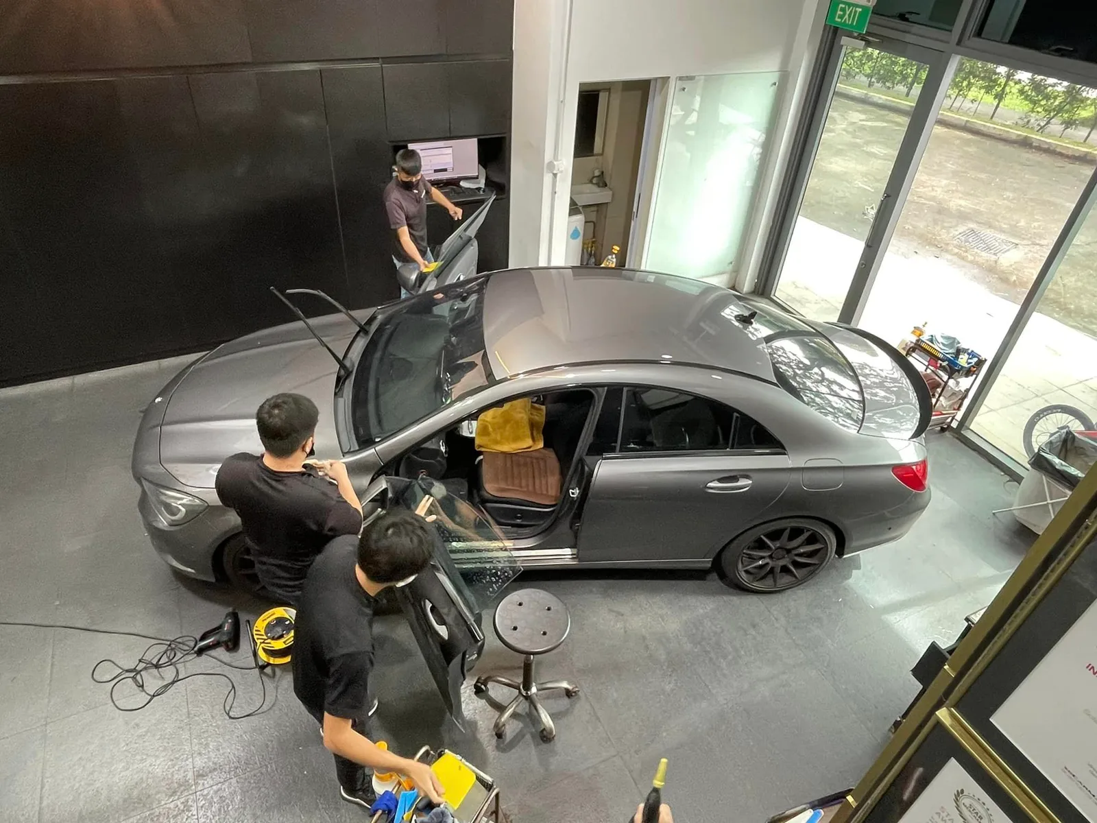 Overhead view of a grey Mercedes-Benz CLA being tinted at Infratint Singapore