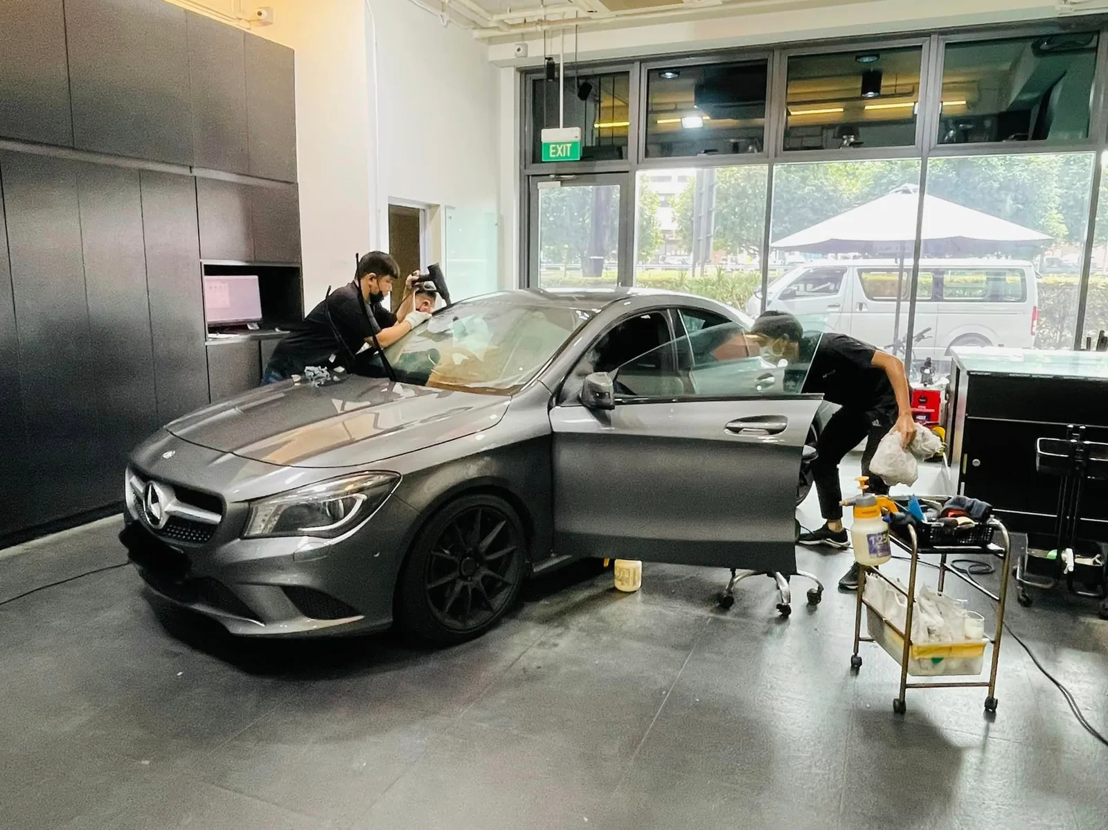 Grey Mercedes-Benz CLA sedan with door open during solar film install at Infratint Singapore