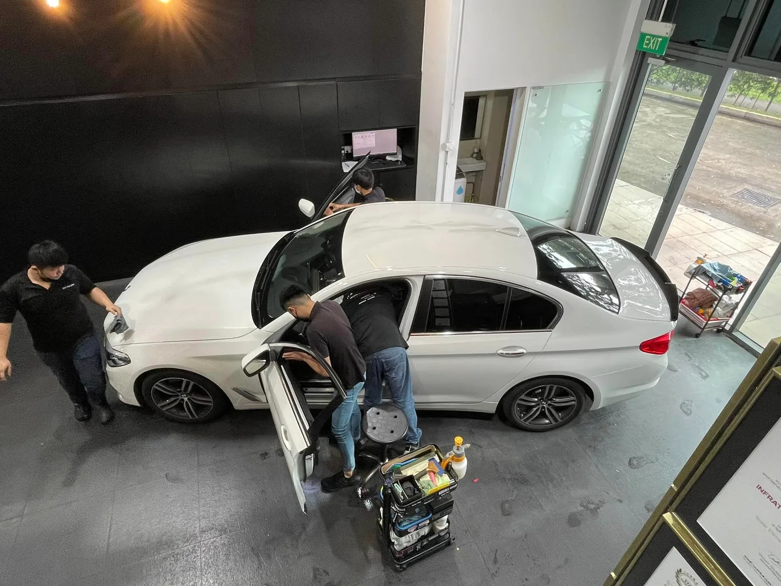 Overhead shot of a white BMW 5 Series being tinted at Infratint Singapore