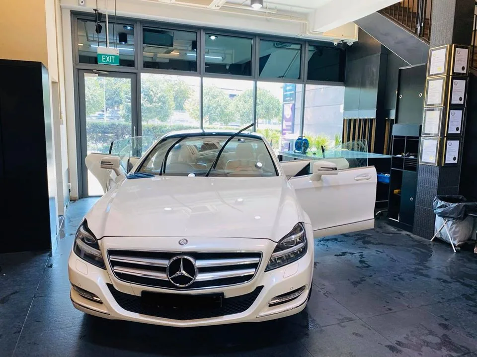 White Mercedes-Benz CLS with doors open for window tinting at Infratint Singapore