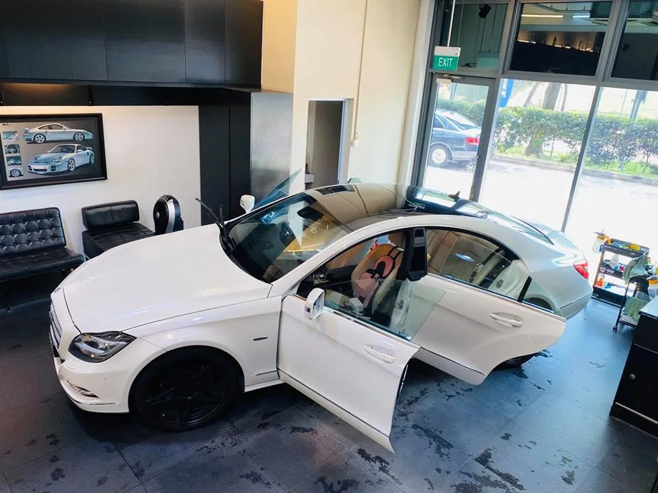 Overhead view of a white Mercedes-Benz CLS during window tinting at Infratint Singapore
