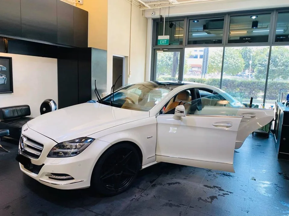 White Mercedes-Benz CLS side profile with black wheels at Infratint Singapore