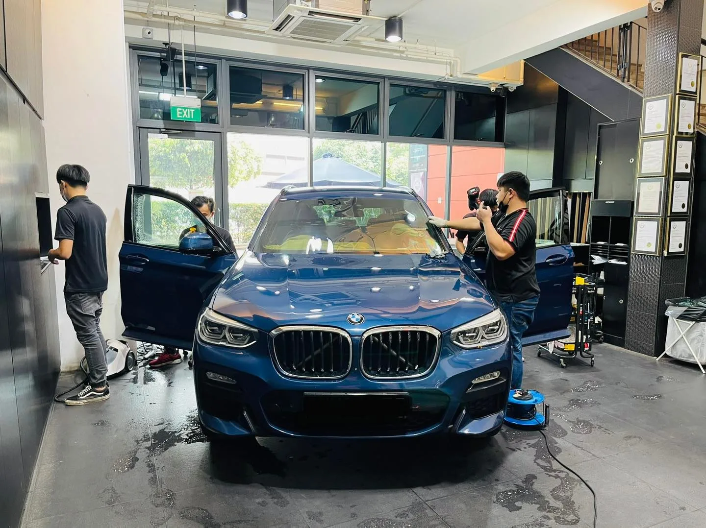 Blue BMW X3 SUV getting its windscreen tinted at Infratint Singapore