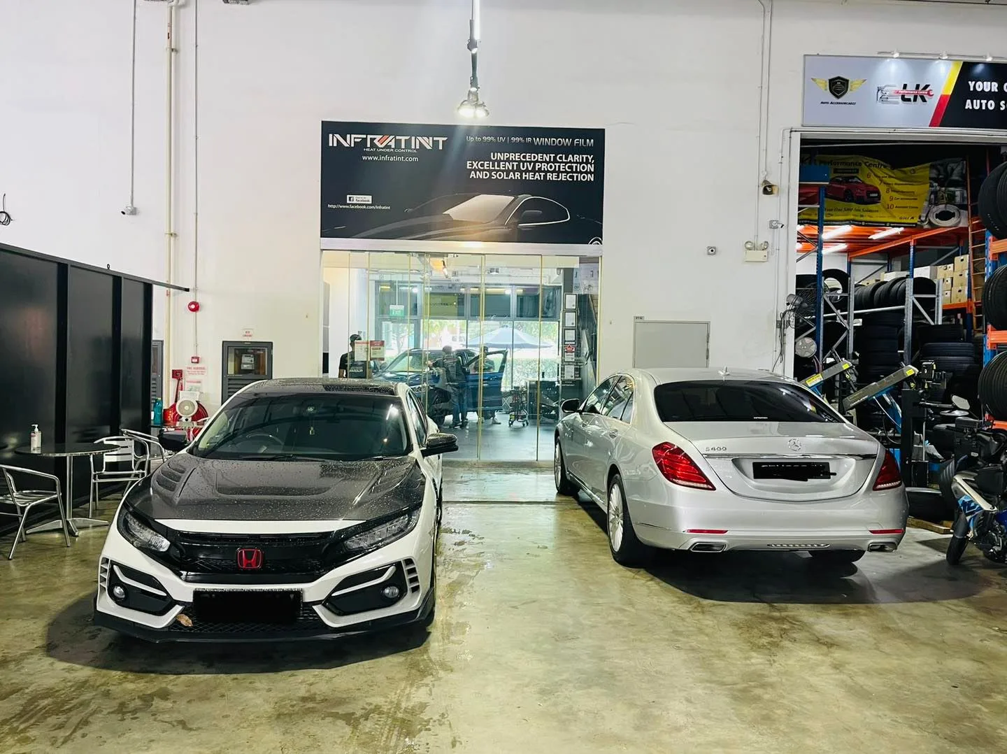 Grey Honda Civic and silver Mercedes-Benz sedan inside the Infratint Singapore showroom