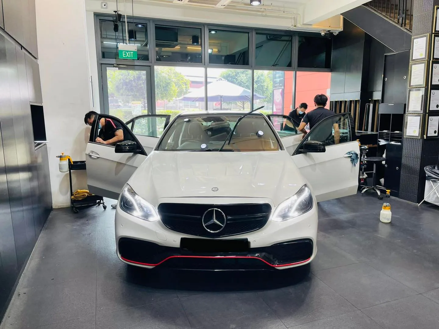 White Mercedes-Benz E-Class being tinted with doors open at Infratint Singapore