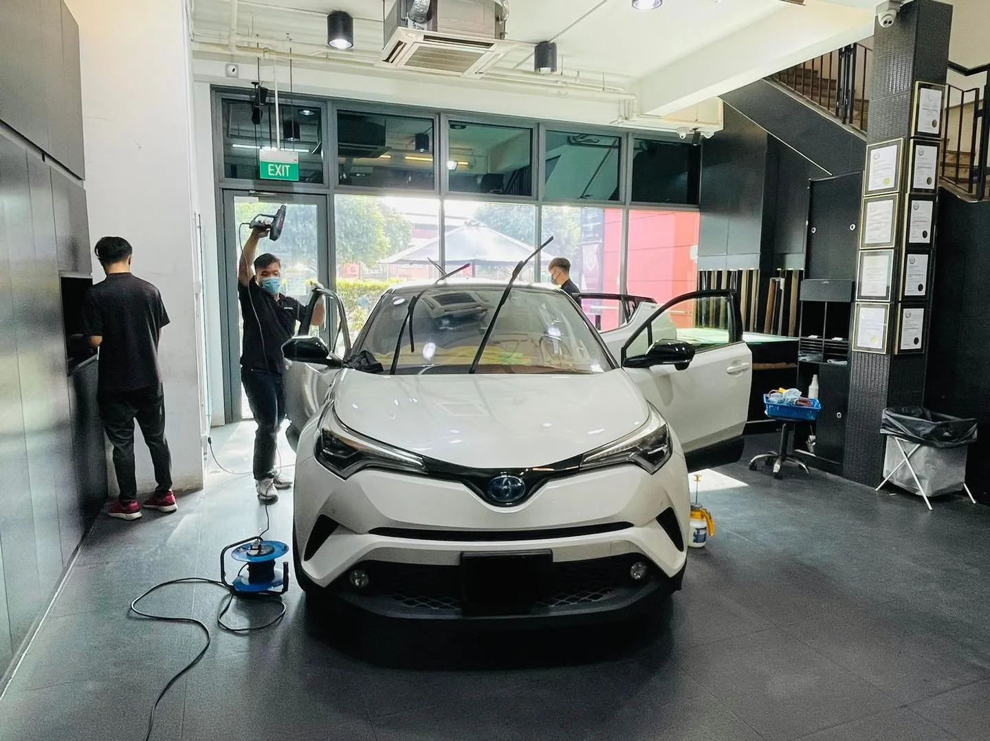 White Toyota C-HR with doors open during window tinting at Infratint Singapore