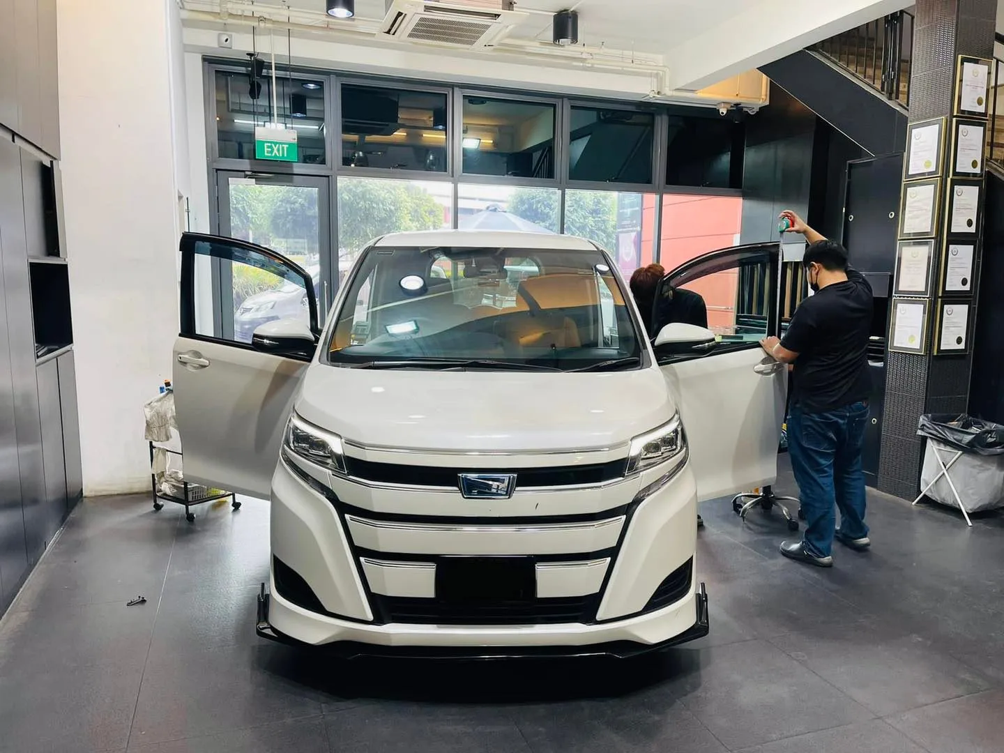 White Toyota MPV with doors open during window tinting at Infratint Singapore