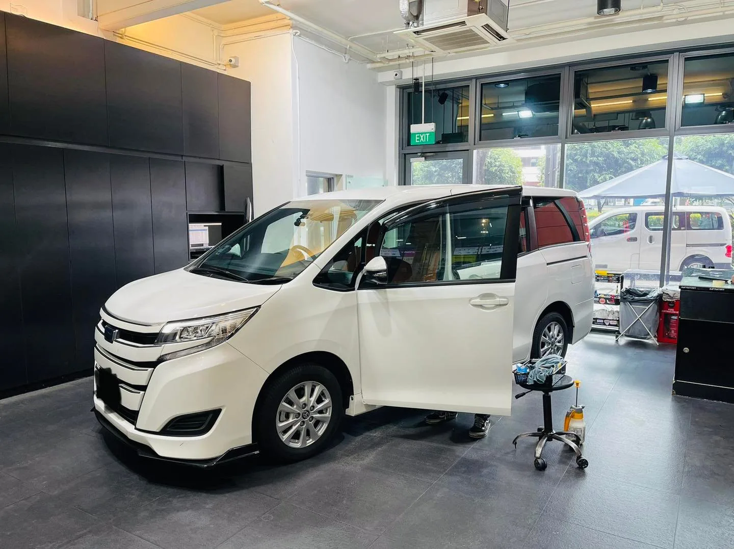 White Toyota MPV side view during window tinting at Infratint Singapore