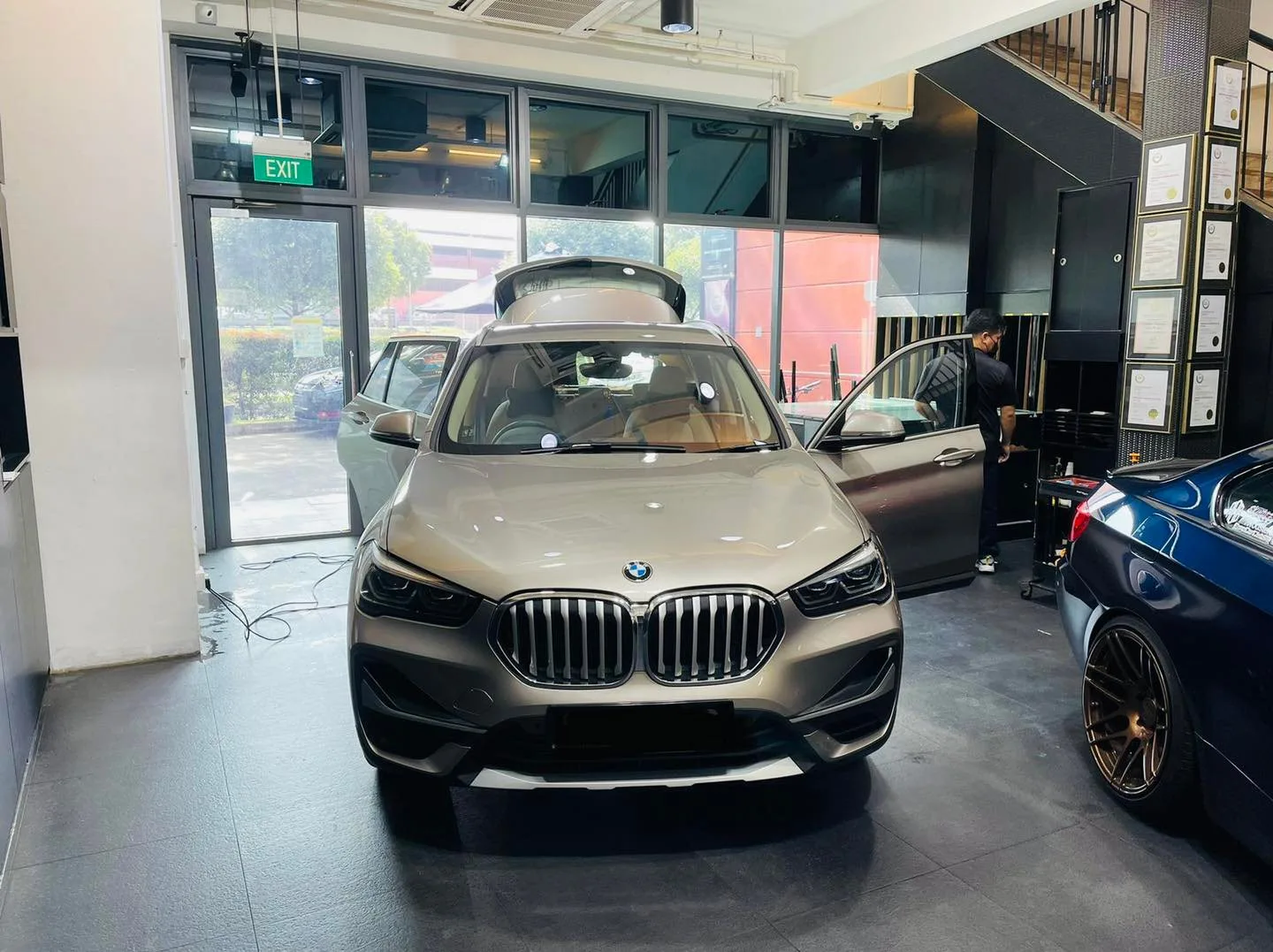Silver BMW SUV front view inside the Infratint Singapore install bay