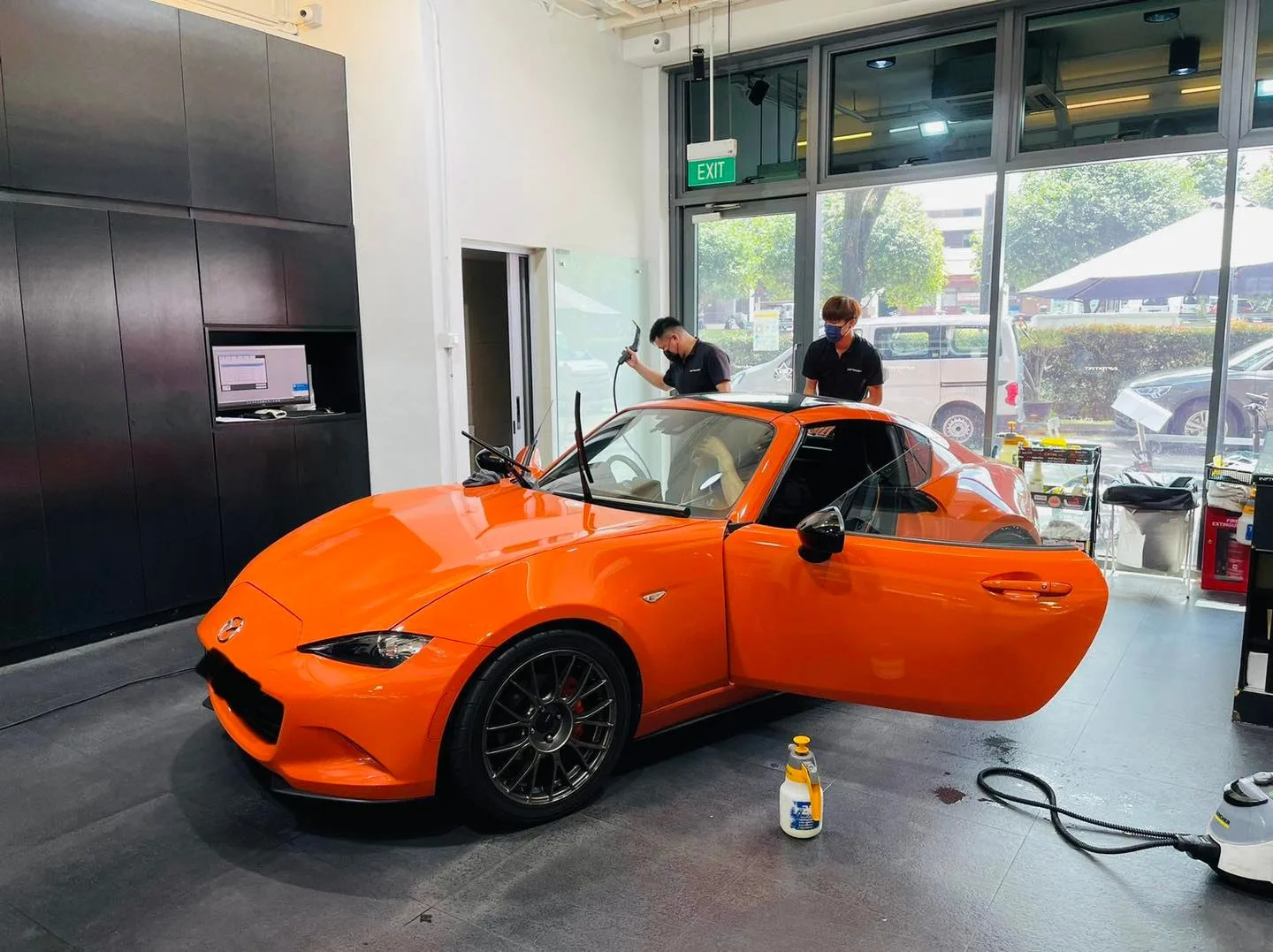 Orange Mazda MX-5 front three-quarter view during window film install at Infratint Singapore