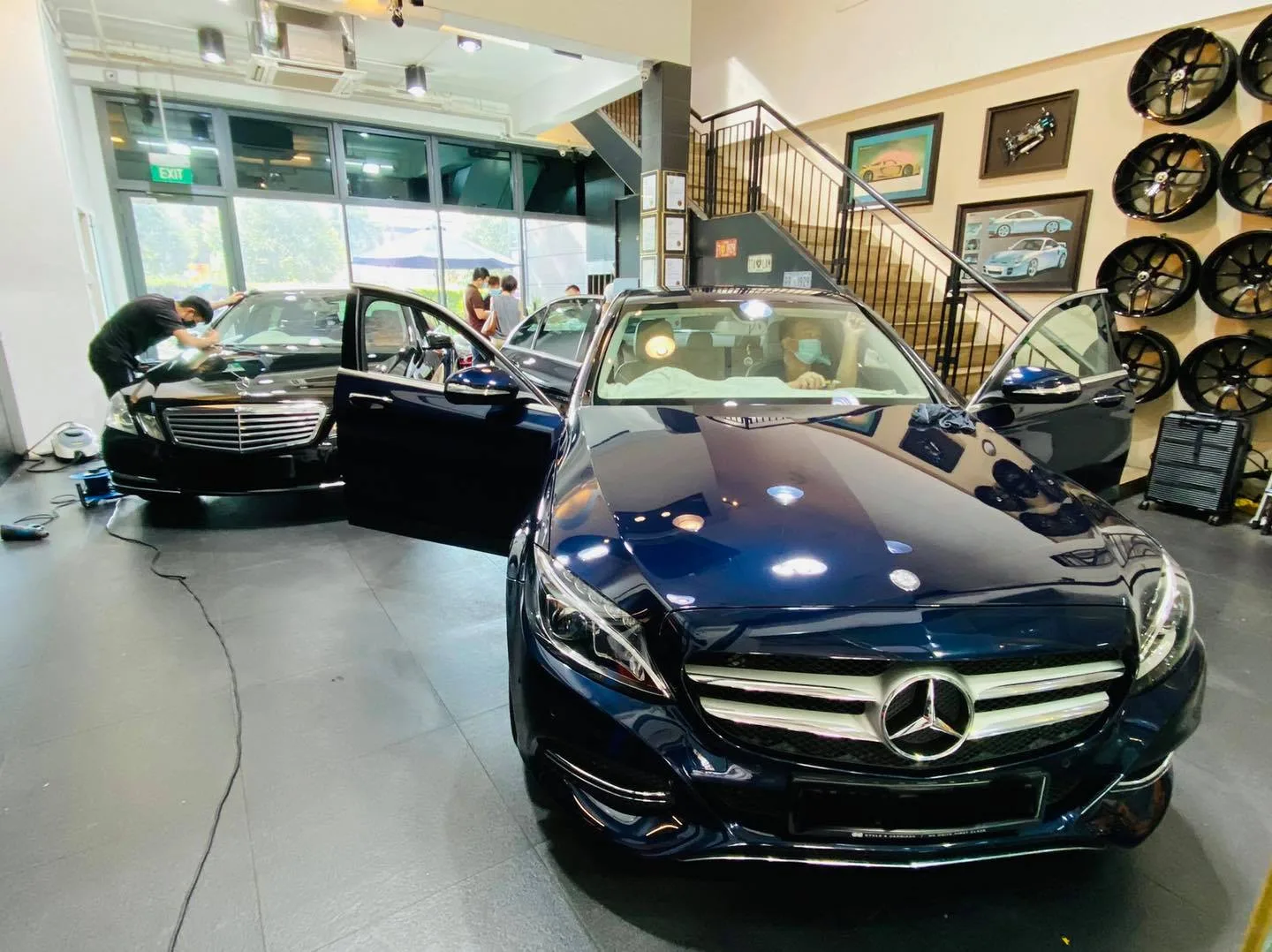 Two dark blue Mercedes-Benz sedans being tinted at Infratint Singapore