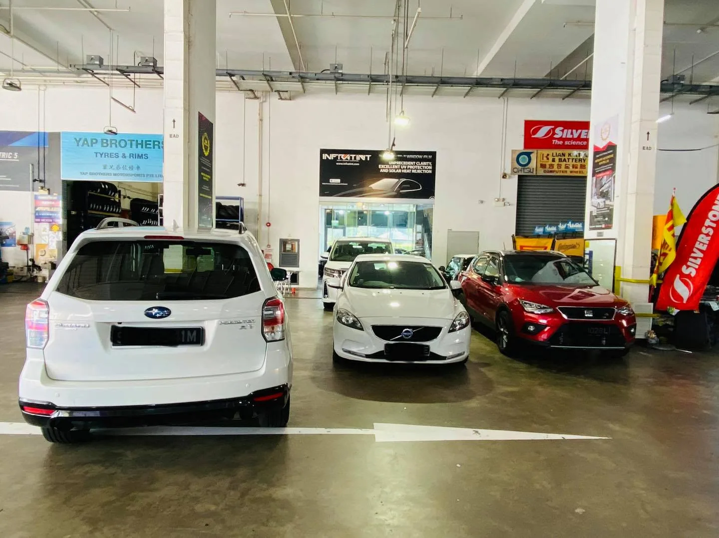 White Subaru Forester, Volvo hatch and red SEAT crossover at Infratint Singapore after window tinting