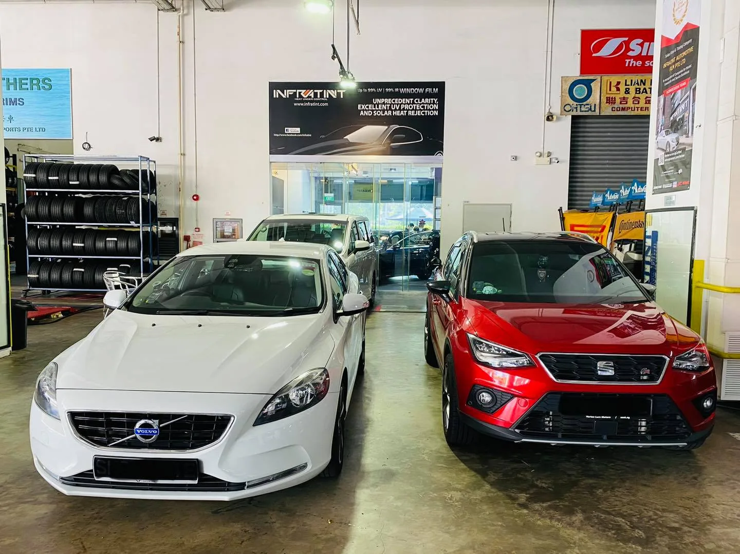 White Volvo hatch and red SEAT crossover at Infratint Singapore for window film
