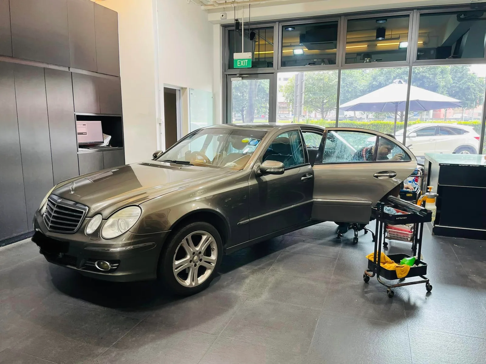 Bronze Mercedes-Benz E-Class front three-quarter during window tinting at Infratint Singapore