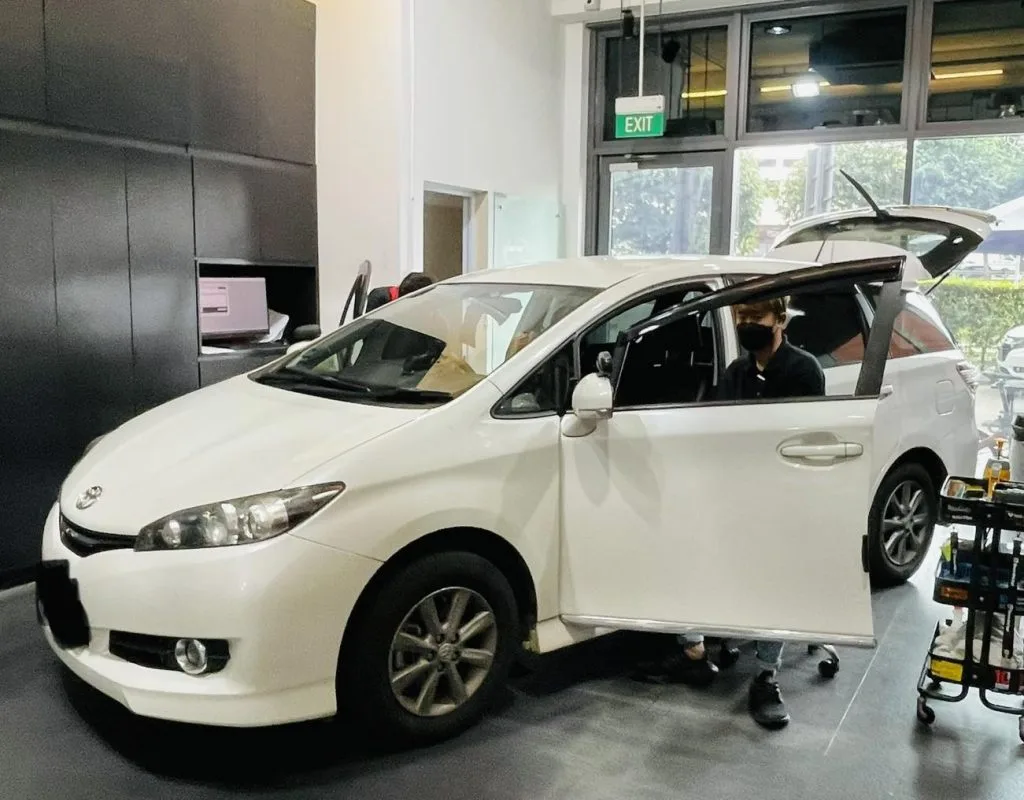 White Toyota Wish MPV side view with tailgate open at Infratint Singapore