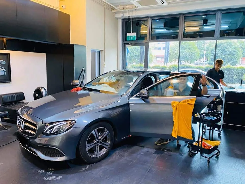 Side view of a graphite Mercedes-Benz E-Class being tinted at Infratint Singapore