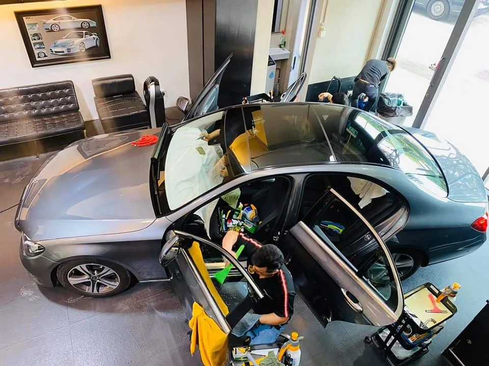 Overhead view of a Mercedes-Benz E-Class with panoramic roof during tinting at Infratint Singapore