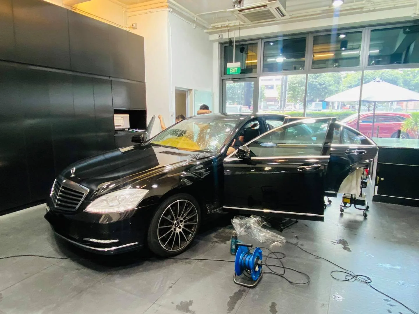 Side view of a black Mercedes-Benz S-Class being tinted at Infratint Singapore