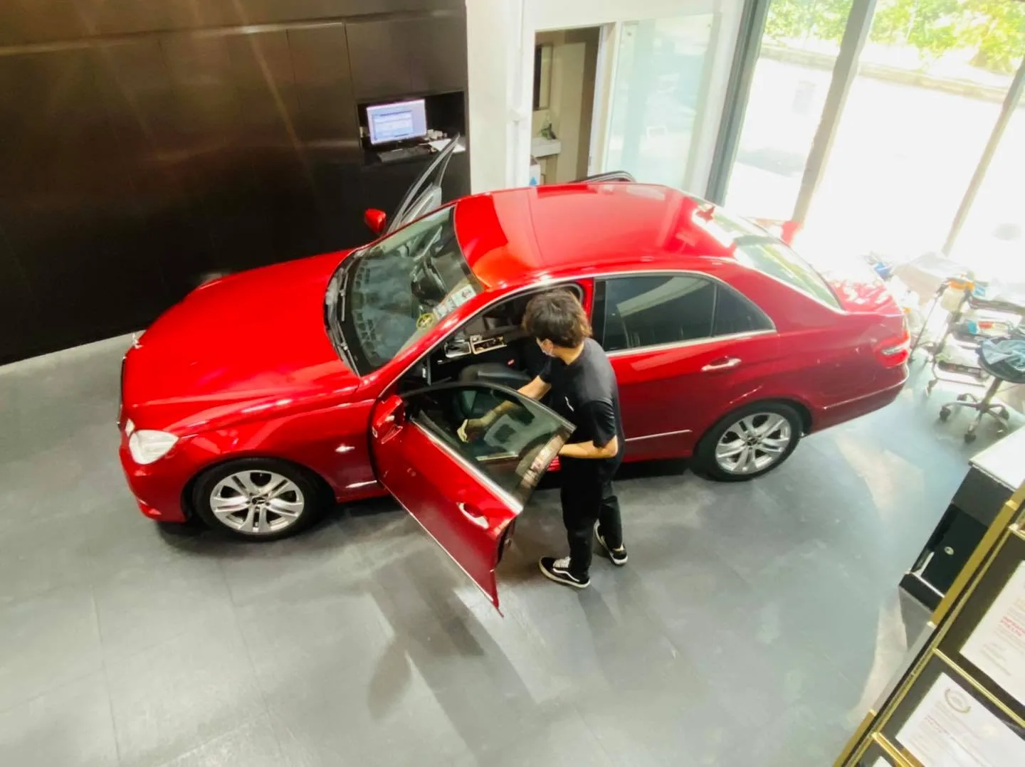 Overhead view of a red Mercedes-Benz E-Class being tinted at Infratint Singapore