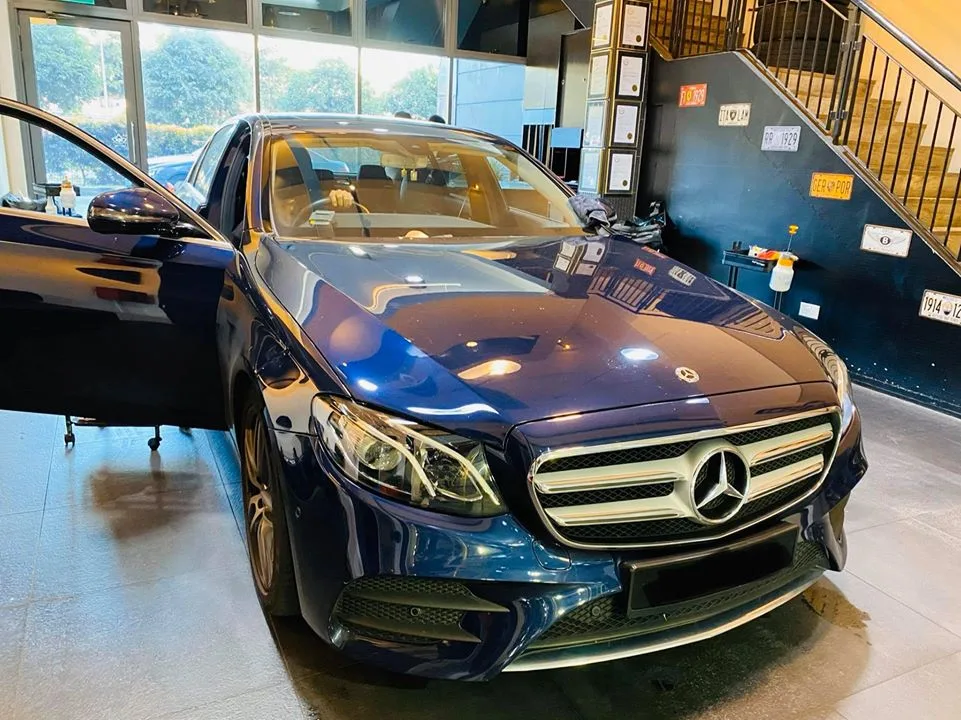 Dark blue Mercedes-Benz sedan ready for window tinting at Infratint Singapore