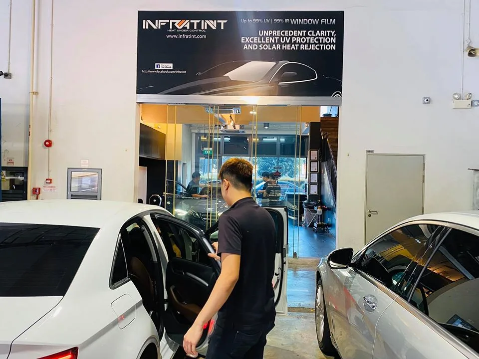 Infratint Singapore entrance banner with cars parked either side of the doorway