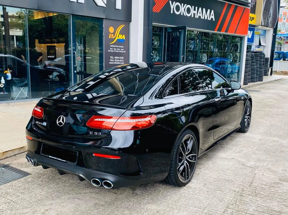Rear of a black Mercedes-AMG E-Class coupe with quad exhausts at Infratint Singapore