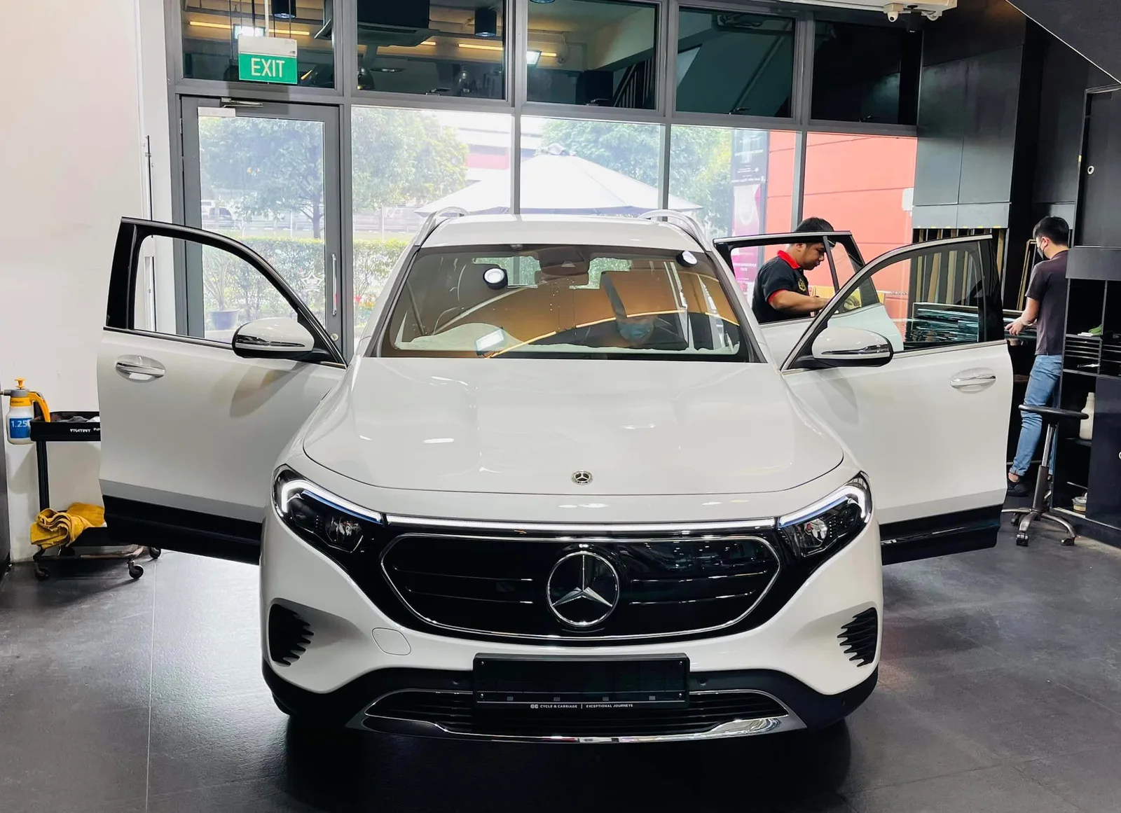 White Mercedes-Benz EQB with doors open during window tinting at Infratint Singapore