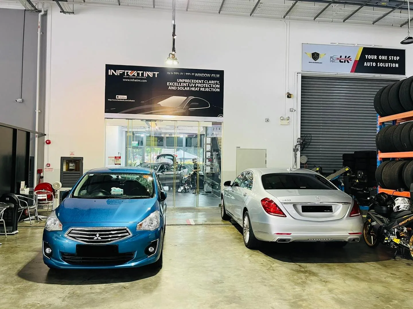 Blue Mitsubishi Attrage and silver Mercedes-Benz S-Class at Infratint Singapore for window film