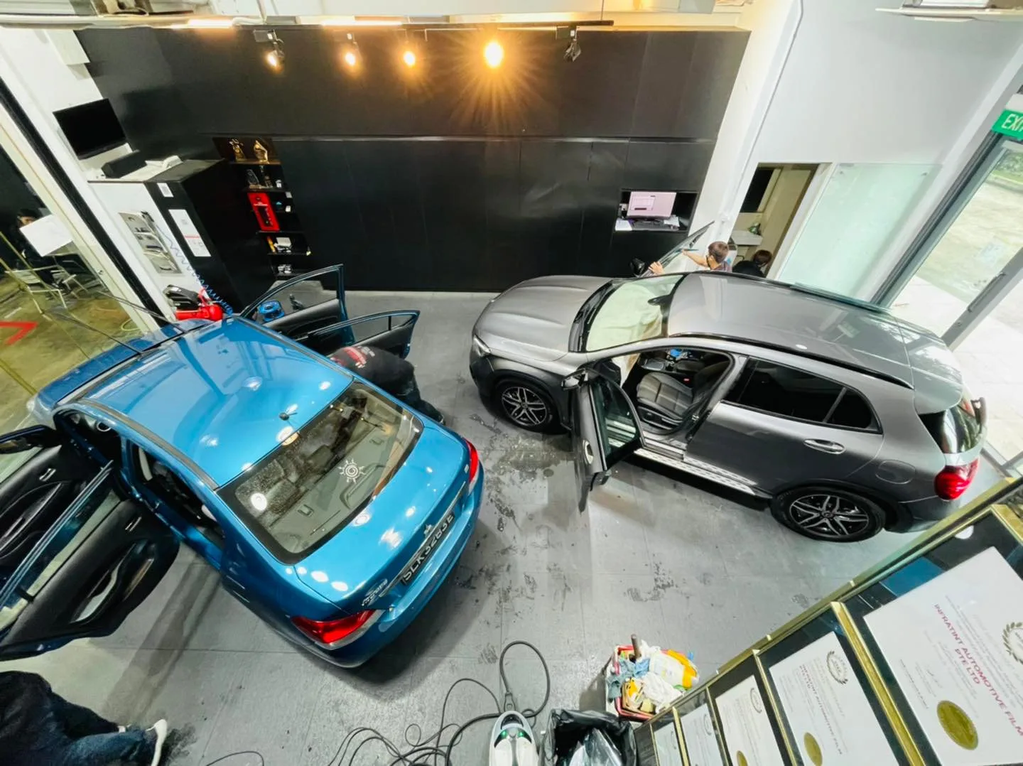Overhead view of a blue sedan and grey Mercedes-Benz GLA at Infratint Singapore