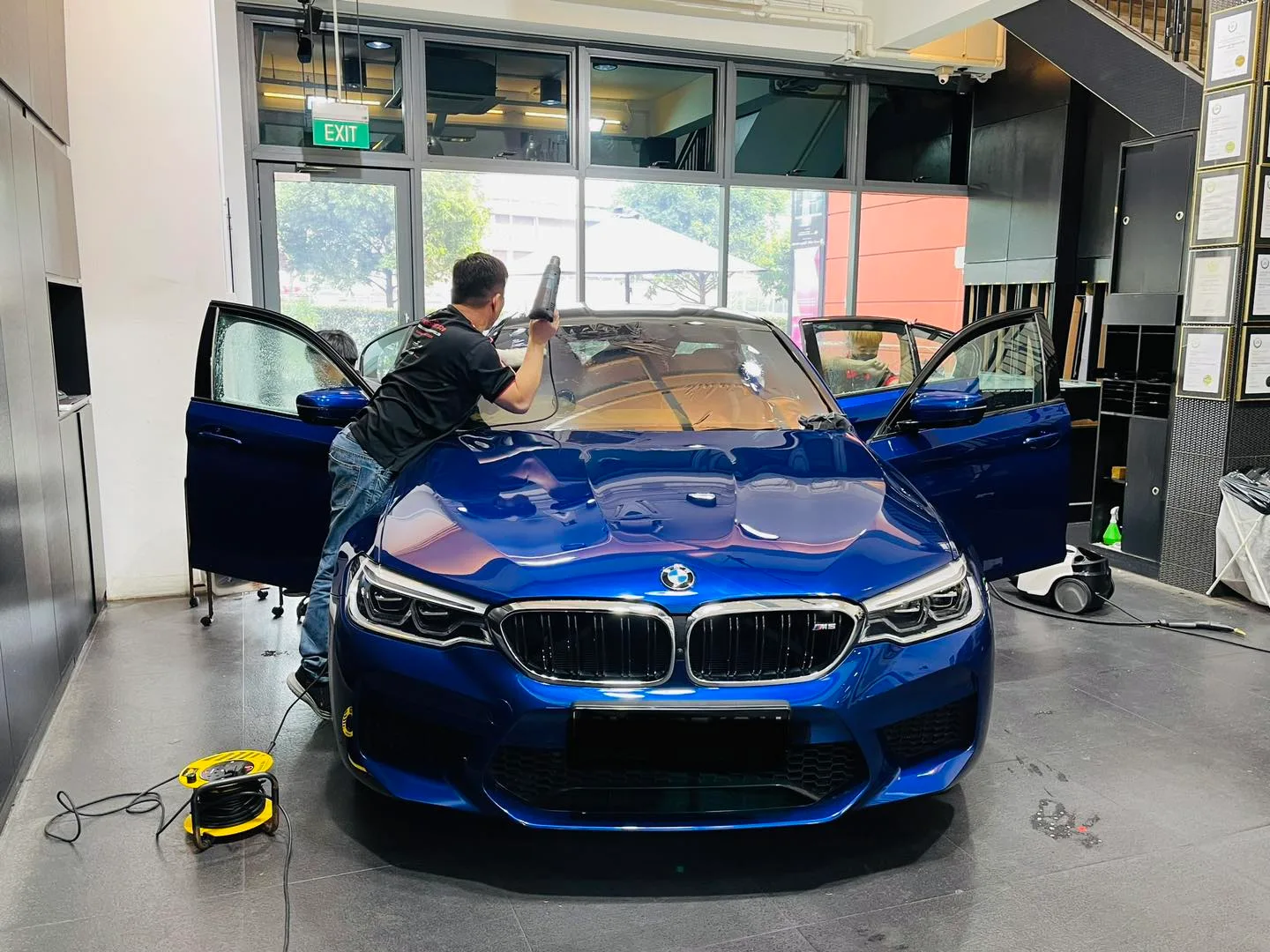 Blue BMW M-Sport sedan having window film applied at Infratint Singapore