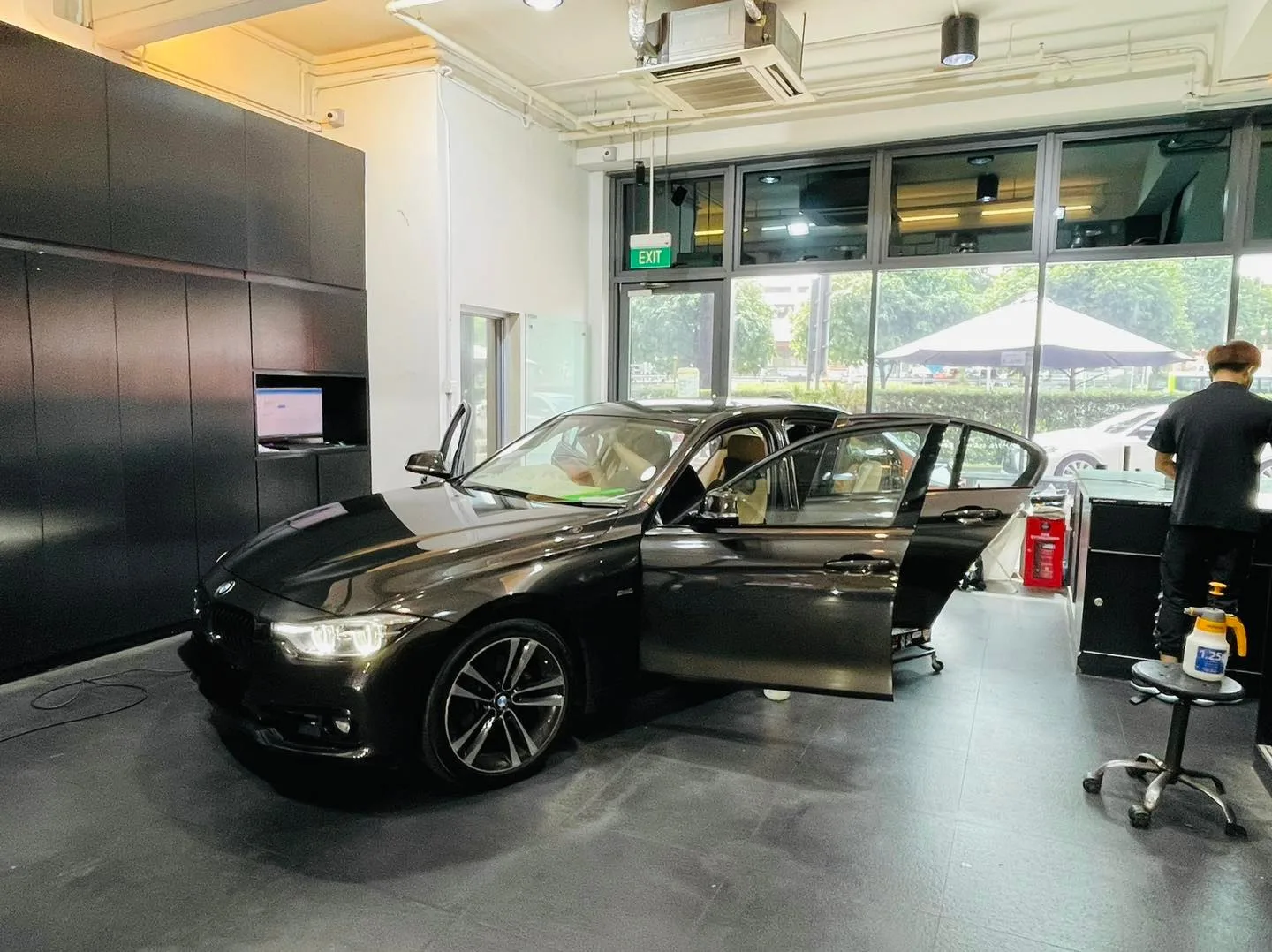 Black BMW sedan during window film installation at Infratint Singapore