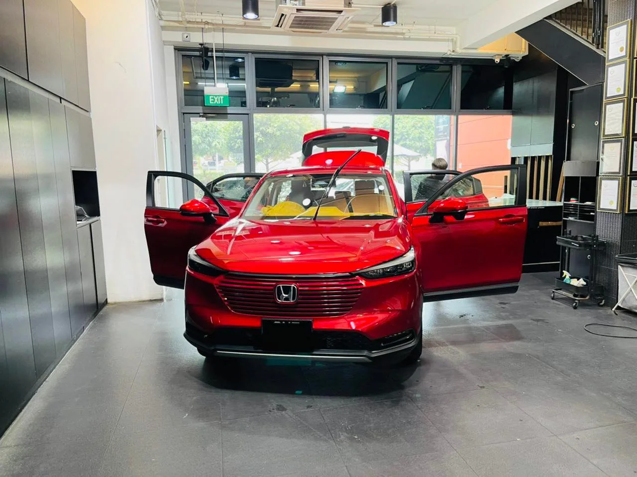 Red Honda SUV with doors and tailgate open at Infratint Singapore for window tinting